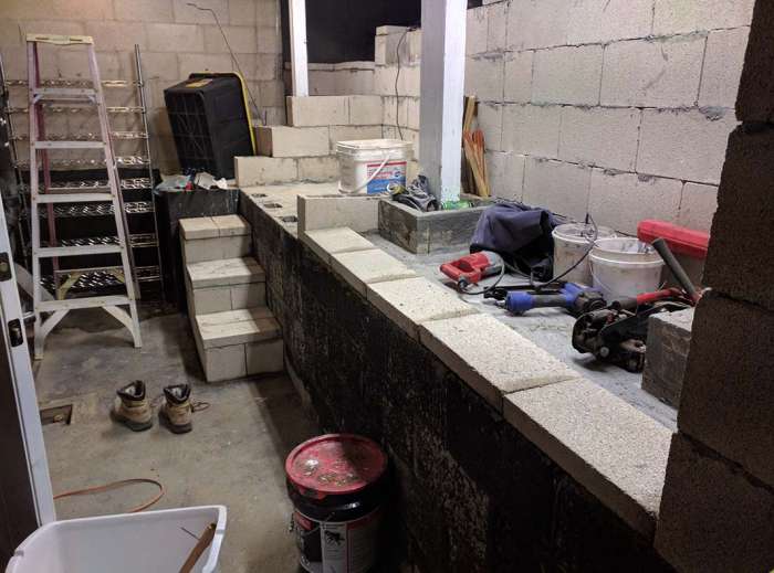 Renovation murder room concrete pour shelving cinder blocks tool storage