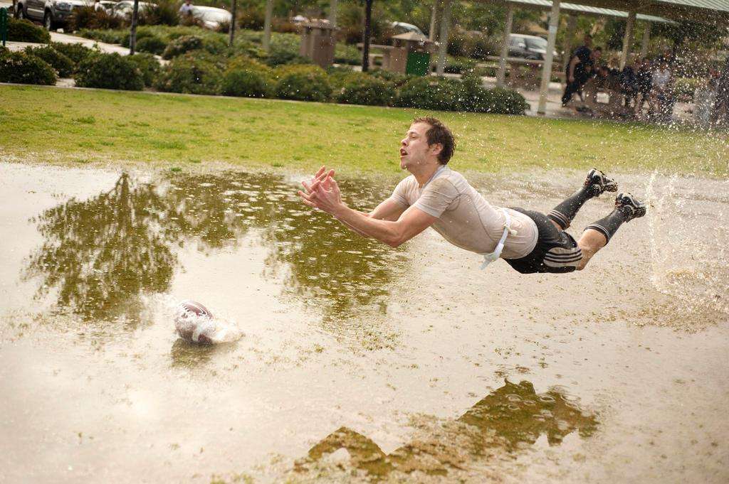 Muddy flag football puddle catch drop