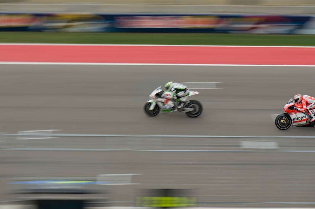 2014 MotoGP Austin Texas Andrea Dovizioso overtake front straight panned
