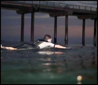 Night surf nightsurf Scripps Pier paddle out led lights sunset