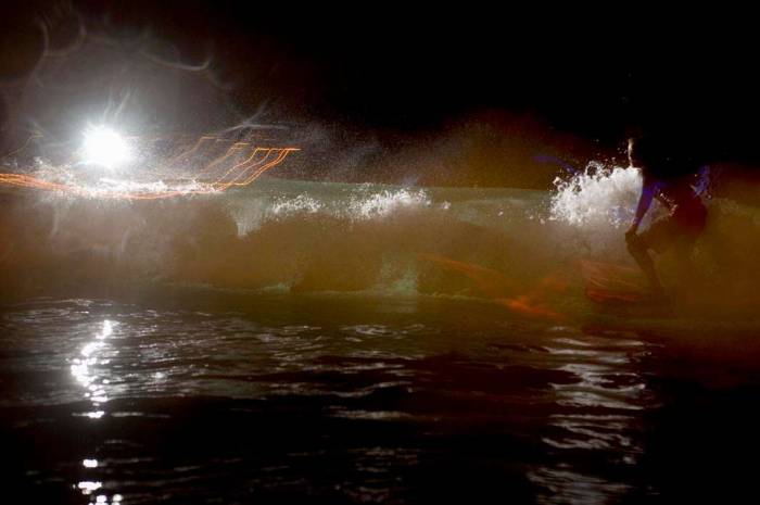 Surfing nightsurfing glow stick backlit wave