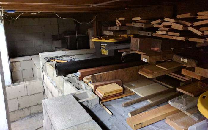Renovation murder room concrete pour shelving cinder blocks lumber storage