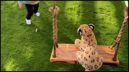 Plush leopard on a swing
