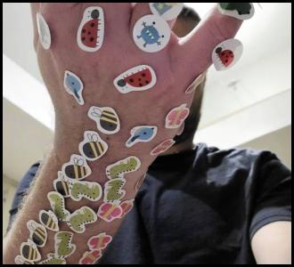 Arm covered in childrens stickers