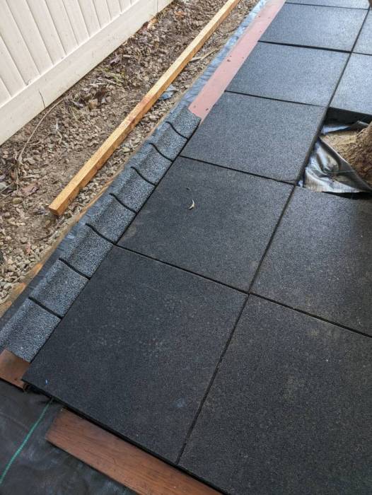 Sideyard renovation playground tile installation rubber curb